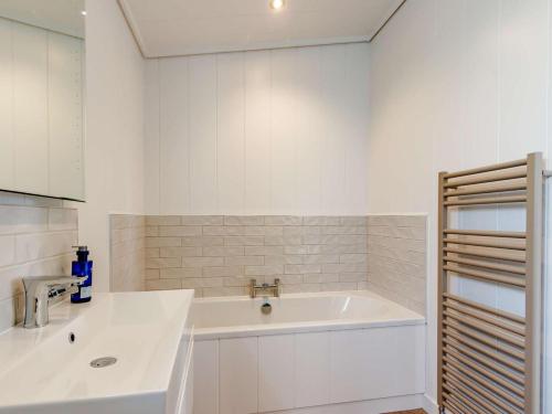 a white kitchen with a sink and a counter at 2 Bed in Anstruther oc-83173 in Anstruther