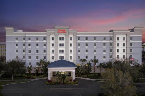 a large white building with a clock on it at Hampton Inn & Suites Lakeland-South Polk Parkway in Lakeland
