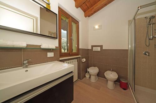a bathroom with a sink and a toilet at Villetta Enzo - Gardagate in Toscolano Maderno