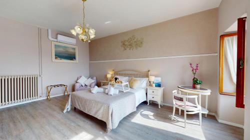 a bedroom with a bed and a table and chairs at Apt Giada Salò magic view in Salò