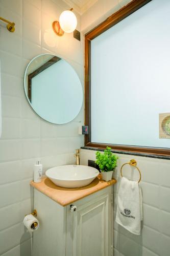 a bathroom with a sink and a mirror at Staymaster Veridian Standard 2BHK Near Calangute Beach in Calangute