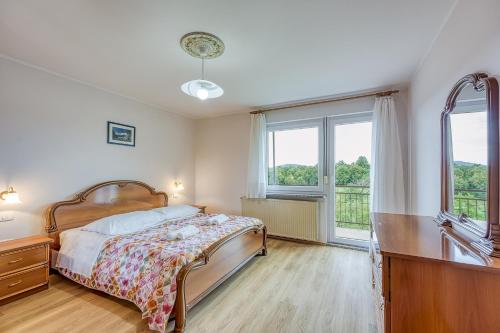 a bedroom with a bed and a dresser and a window at Apartma pri Cesarjevih in Sežana