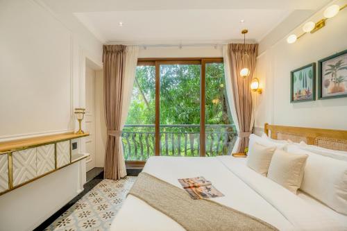 a bedroom with a bed and a large window at Staymaster Veridian Standard 2BHK Near Calangute Beach in Calangute