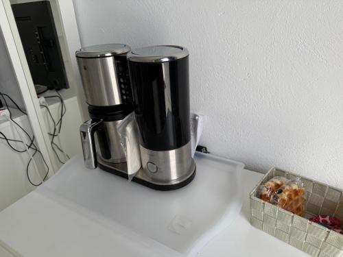 a coffee maker on a counter with a box of donuts at La dolce vita in Mala
