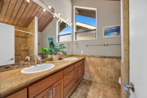 a bathroom with two sinks and a large mirror at Kahana Village 9 · KHV 9 2BR Oceanfront Condo w Panoramic Maui in Lahaina