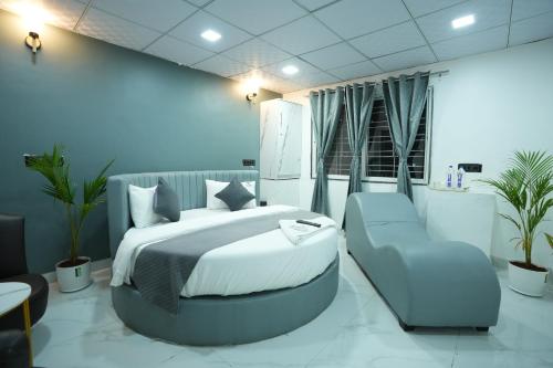 a hotel room with a bed and a chair at Elysia By THL-Near Westend Mall Aundh in Pune