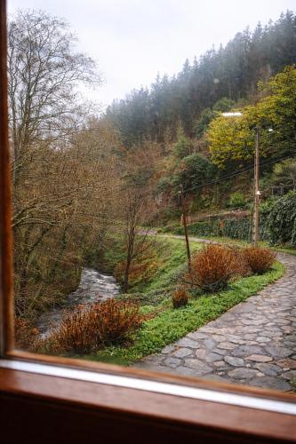 a view of a stone path from a window at Casa do Fidalgo in A Pontenova