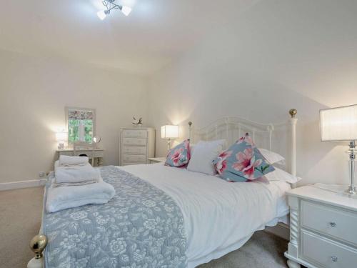 a bedroom with a large white bed with pillows at 3 Bed in Langholm oc-95053 in Langholm