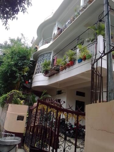 a balcony of a house with potted plants on it at BiJOY VILLA in Guwahati