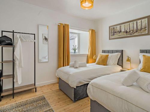 a bedroom with two beds and a window at 3 Bed in Crieff oc-92683 in Madderty