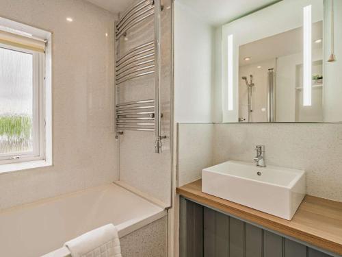a white bathroom with a sink and a mirror at 3 Bed in Crieff oc-92683 in Madderty