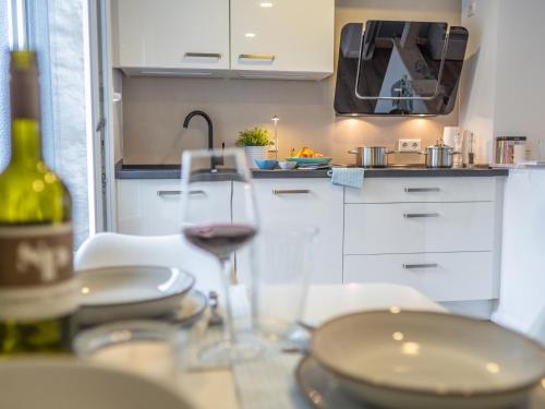 a glass of wine sitting on a table in a kitchen at Hafensternchen in Husum
