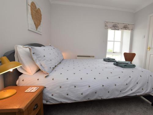 a bedroom with a bed and a desk and a window at 1 Bed in Biggar oc-82923 in Biggar