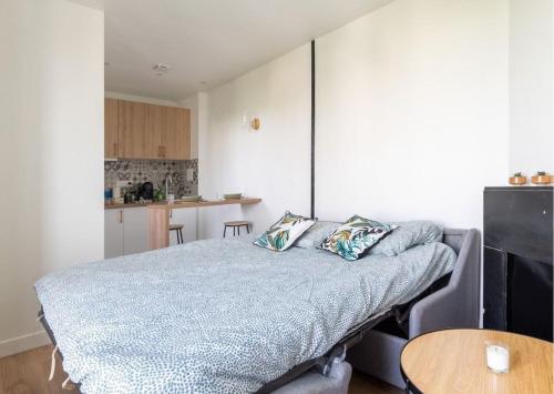 a bedroom with a bed with two pillows on it at L'espace de Robespierre in Saint-Denis