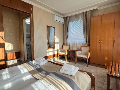a hotel room with a bed and a table and chairs at Garni Hotel Lav in Belgrade