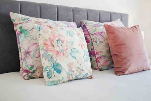 a group of pillows sitting on a bed at Central Condo-Pool with AC and garden by Algarve Dream Holidays in Albufeira