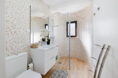 a bathroom with a white sink and a mirror at Central Condo-Pool with AC and garden by Algarve Dream Holidays in Albufeira