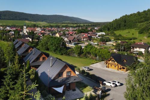 an aerial view of a village with houses and cars at Zrub pod Roháčmi in Zuberec