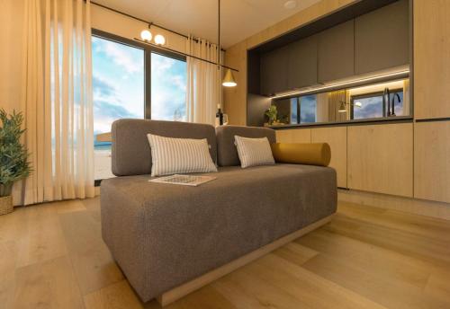 a couch in a living room with a large window at Vista Mare , Cap corse in Meria