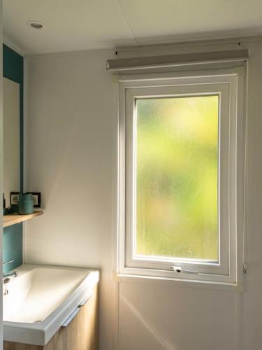 a bathroom with a window next to a sink at Vista Mare , Cap corse in Meria