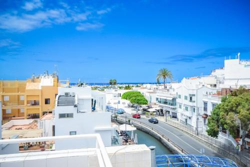 a view of a city with buildings and a street at Casa Arno - Lovely Renovated Apartment In Playa De Mogan in Puerto de Mogán