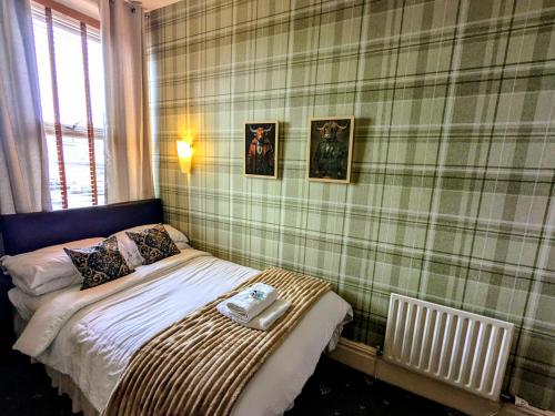 a small bedroom with a bed and a radiator at The Dame Lane in Blackpool