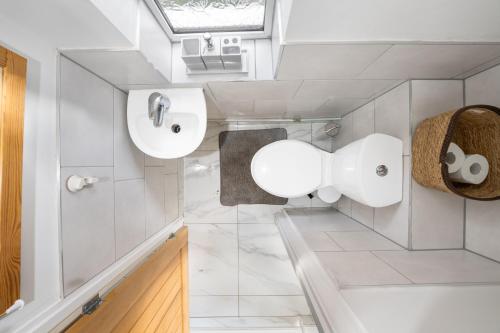 a bathroom with two sinks and two mirrors at Delves House in Bescot