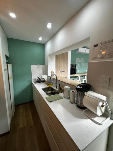 a kitchen with a sink and a counter top at Pepe Hostel Boutique in Neuquén