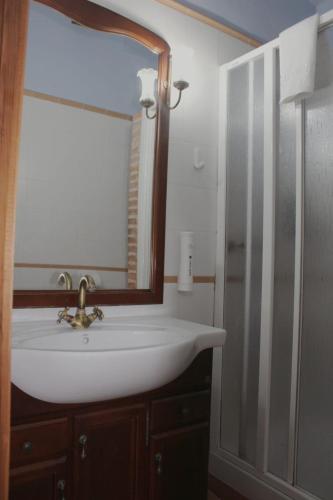a bathroom with a white sink and a mirror at Fonda la Plaza in Valderrobres