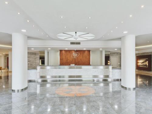 a lobby with a reception desk in a building at Hotel Planet International in Arezzo