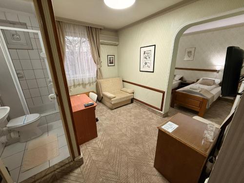 a hotel room with a bathroom and a bedroom at Garni Hotel Lav in Belgrade