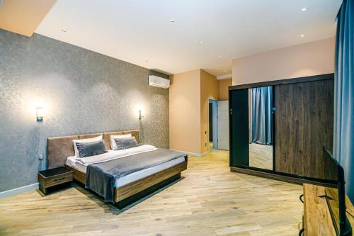 a bedroom with a bed and a large window at Lanai Villas Beach Side in Baku