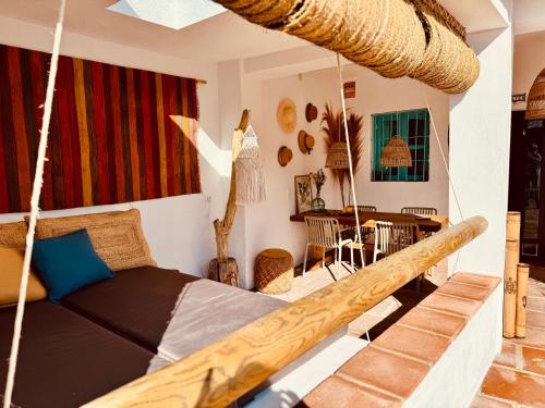 a bedroom with a swing bed and a table at Casa Bambú Boutique Studios Andalusië with pool and Mountain Views in Vélez-Málaga