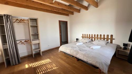 a bedroom with a large bed in a room at Chambres d'Hôtes de Marchet in Auvillar