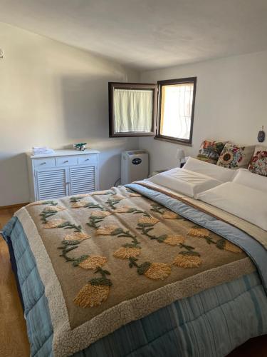 a bedroom with a large bed with a blanket on it at Arcangelo SUITE in Assisi