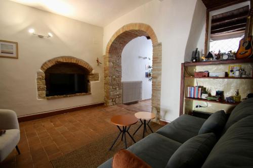 a living room with a couch and a fireplace at La Casa di Oli in Amelia