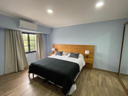a bedroom with a large bed in a room at El Viejo Albergue in Luján