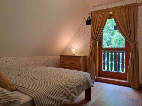 a bedroom with a bed and a window at Drevenica pod Lánom in Zuberec