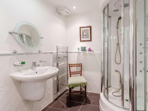 a white bathroom with a sink and a shower at 4 Bed in Pitlochry oc-ca274 in Foss