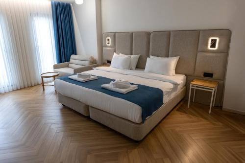 a hotel room with a large bed and a chair at Linza Suite in Babaeski