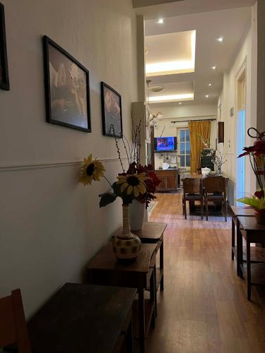 a living room with a vase of flowers on the wall at Hotel Acropolis in Kavála