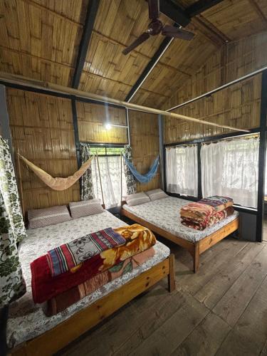 a bedroom with two beds in a wooden house at Verde Guest House in Shillong
