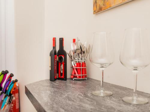 two wine bottles and glasses on a table at The Art Studio in Bath