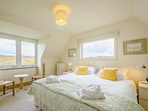 a bedroom with a large bed with yellow pillows at 4 Bed in Scourie oc-ca399 in Scourie
