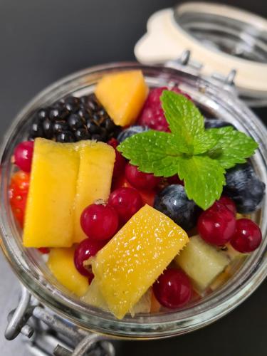 a glass bowl filled with different fruits and berries at Villa de Hazelaar in Schoorl