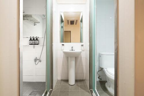 a bathroom with a sink and a toilet at K9 Myeongdong Hotel in Seoul
