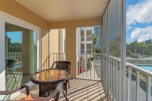 a patio with a table and chairs on a balcony at Palm Beach Landings A107 in Fort Myers