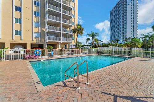 a swimming pool in front of a apartment building at Palm Beach Landings A107 in Fort Myers