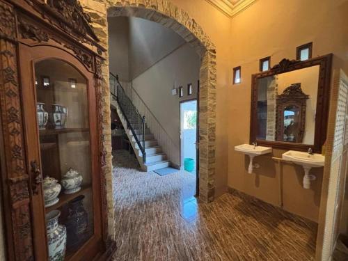 a hallway with two sinks and a staircase in a house at Good Feeling Ijen Banyuwangi in Banyuwangi
