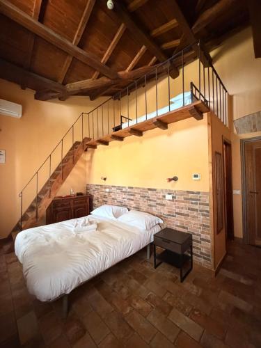 a large bed in a room with a staircase at Il Casale Di Roma in Prima Porta